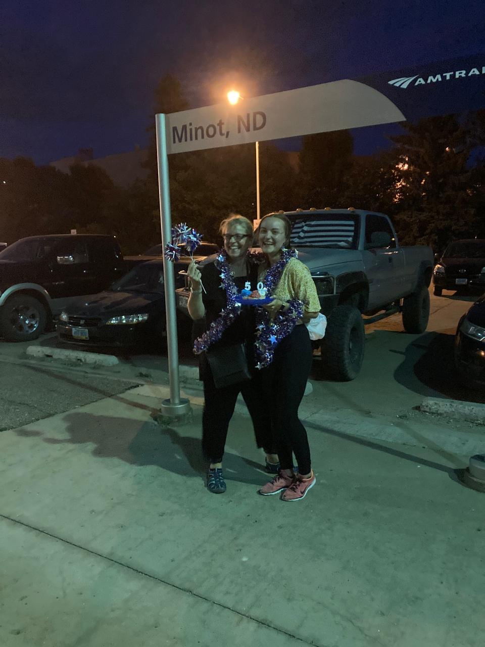 Sabine and Victoria, a mother and daughter duo from Germany, celebrate visiting their 50th state at 11 p.m. during a fresh air break in Minot, North Dakota.