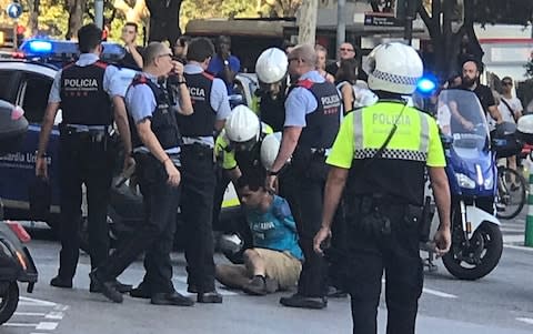 Police detain a possible suspect after the Barcelona attack - Credit: Jason Yu/Twitter