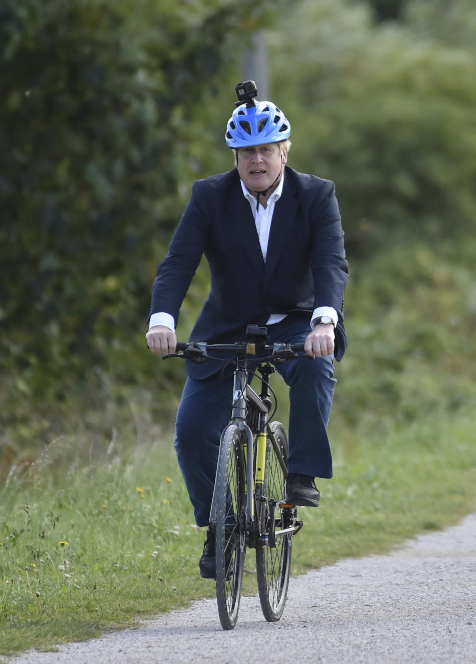 Britain's Prime Minister Boris Johnson cycles at the Canal Side Heritage Centre in Beeston near Nottingham, England, Tuesday, July 28, 2020. The government is launching a new cycling initiative to help get people fitter. (AP Photo/Rui Vieira, Pool)