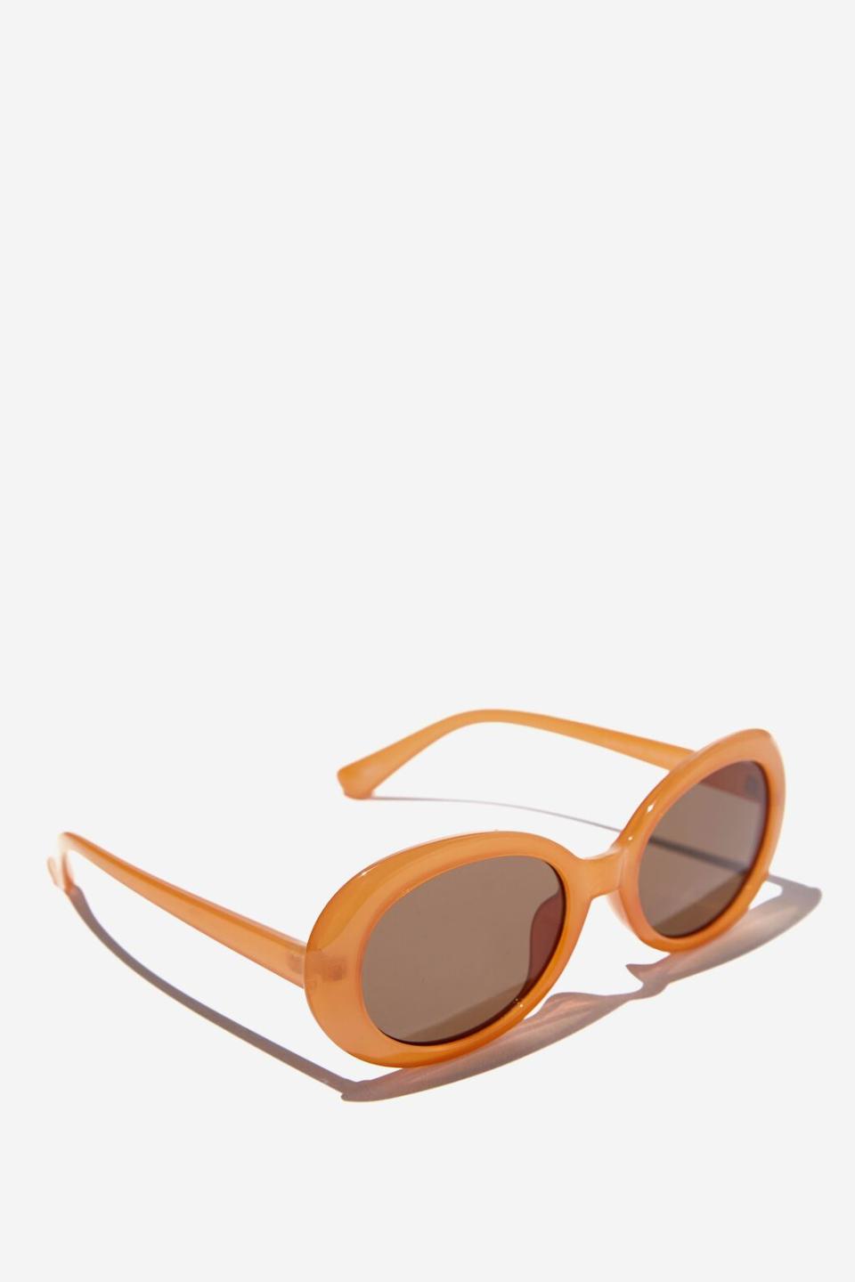 Burnished oval sunglasses with darker lenses. Olivia Oval Sunglasses, $19.99