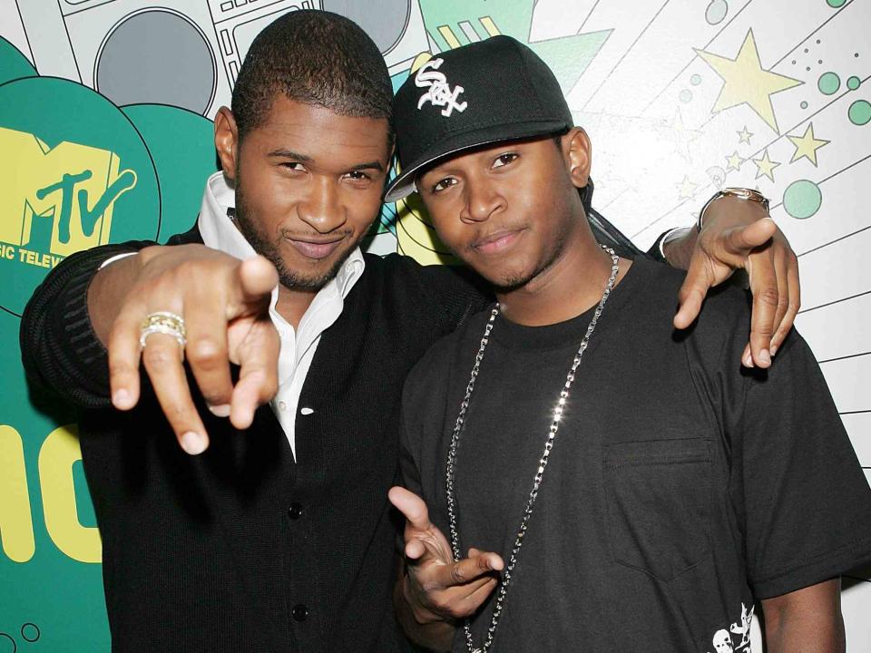 <p>Scott Gries/Getty</p> Usher and his brother James Lackey backstage during MTV