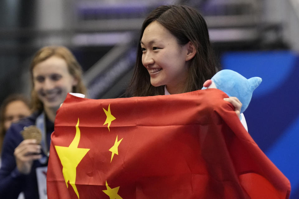 Bronze medalist Li Bingjie of China holds her flag during ceremonies at women's 1500m freestyle finals at the World Swimming Championships in Fukuoka, Japan, Tuesday, July 25, 2023. (AP Photo/Lee Jin-man)