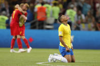 <p>Thiago Silva looks to the heavens as Belgium players celebrate their famous win. </p>