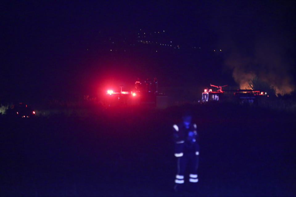 A night view of the site of a plane crash, a few miles away from the city of Kavala, in northern Greece, on Saturday, July 16, 2022. An Antonov cargo plane operated by a Ukraine-based air carrier crashed Saturday near the city of Kavala in northern Greece, authorities said. Greek Civil Aviation authorities say the flight was heading from Serbia to Jordan, but have not been able to confirm how many people were on board or what the plane's cargo was. (Ilias Kotsireas/InTime News via AP)