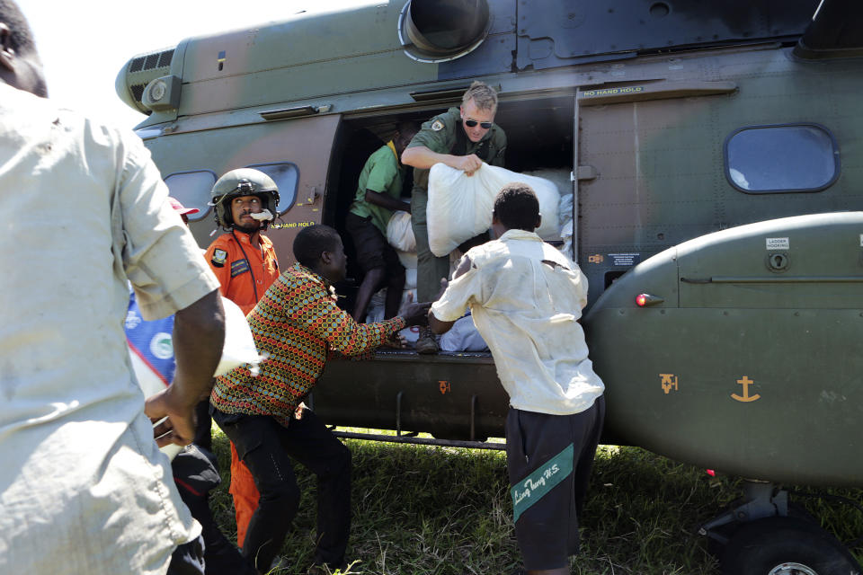 Food supplies are dropped off by helicopter near Nhamatanda, about 130km from Beira, in Mozambique, Tuesday, March, 26, 2019. Relief operations pressed into remote areas of central Mozambique where an unknown number of people remain without aid more than 10 days after a cyclone ripped across the country, while trucks attempted to reach the hard-hit city of Beira on a badly damaged road. (AP Photo/Tsvangirayi Mukwazhi)