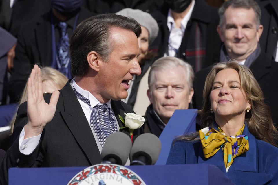 Virginia Gov. Glenn Youngkin is sworn into office as his wife Suzanne looks on at the Capitol Saturday Jan. 15, 2022, in Richmond, Va. (AP Photo/Steve Helber)