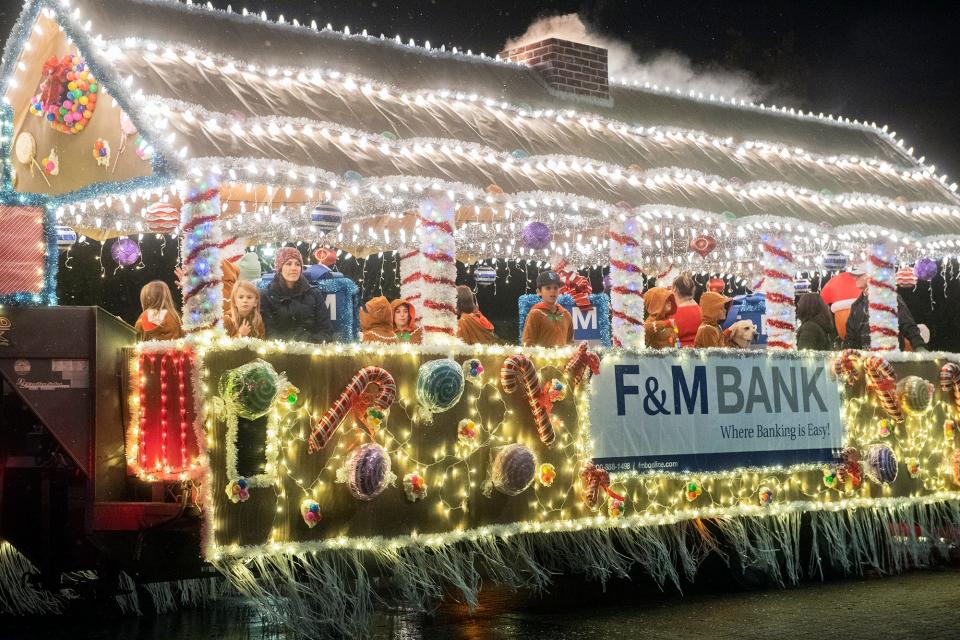 The F & M Bank float rolls down Church Street in the Kiwanis Club of Greater Lodi's annual Parade of Lights in downtown Lodi on Thursday, Dec. 1, 2022. More than 80 floats washed in a sea of lights, marching bands, dance groups, and themed vehicles participated in the Lodi traditional kickoff to the Christmas season.