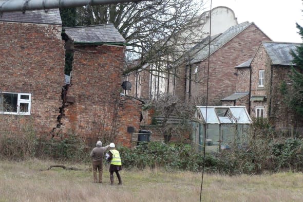 A large crack in a house in Magdalen's Close, Ripon after a huge sinkhole has opened up in the street. PRESS ASSOCIATION Photo. Picture date: Tuesday February 18, 2014. Police cleared the properties on Magdalen's Close in Ripon, North Yorkshire, at 5.40pm after receiving reports the huge sinkhole had appeared. Officers carried out house-to-house checks in the area to warn people close to the affected properties. Police, fire crews and the ambulance service remained at the scene with utility services' engineers and structural engineers who were assisting with the incident. See PA story WEATHER Floods. Photo credit should read: Dave Higgens/PA Wire