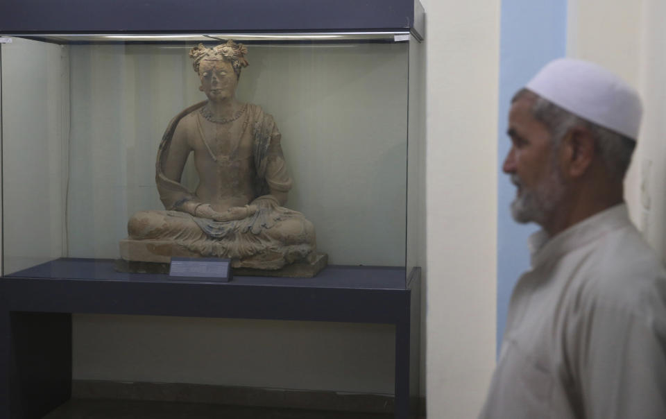 In this Saturday, Aug. 17, 2019 photo, a complete figure of a seated Buddha dating from the third or fourth century is on display at the National Museum of Afghanistan in Kabul, Afghanistan. As an Afghanistan peace deal nears, museum workers rush to restore art shattered by Taliban amid fears over its return. Conservator Sherazuddin Saifi remembers the day the Taliban arrived at the national museum in 2001, a period of cultural rampage in which the world’s largest standing Buddha statues in Bamyan province were dynamited, to global horror. (AP Photo/Rafiq Maqbool)
