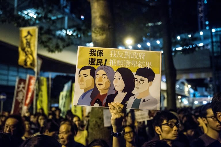 Protestors rally in Hong Kong after four pro-democracy lawmakers were disqualified