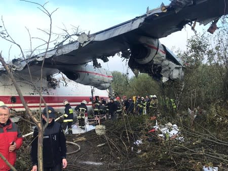 Members of emergency services work at the site of the Antonov-12 cargo airplane emergency landing in Lviv region