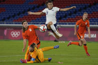 FILE - United States' Alex Morgan jumps over Netherlands' goalkeeper Sari van Veenendaal as she attempts to score during a women's quarterfinal soccer match at the 2020 Summer Olympics, Friday, July 30, 2021, in Yokohama, Japan. The U.S. Equal Employment Opportunity Commission has asked for permission to participate in the appeal by American women soccer players trying to reinstate their pay claim against the U.S. Soccer Federation. The EEOC asked the 9th U.S. Circuit Court of Appeals on Thursday, Feb. 3, 2022, to be allowed to address the court during oral arguments scheduled for March 7 in Pasadena, California.(AP Photo/Kiichiro Sato, File)