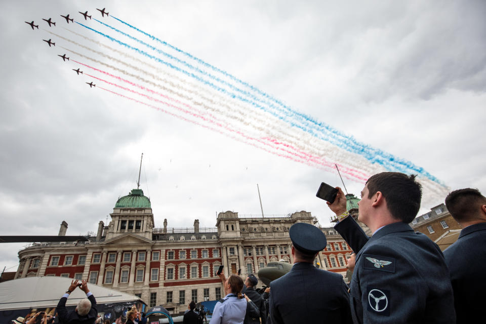 Members of the Royal Air Force watch the Red Arrows flypast over Horse Guards Parade during RAF 100 [Photo: Getty]