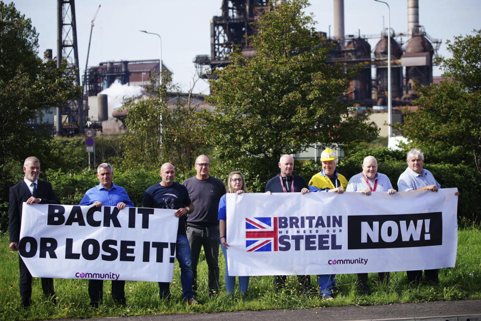Workers hold placards outside Tata Steel's Port Talbot steelworks in south Wales, as around 3,000 jobs are at risk at the plant as part of a planned restructuring, on Friday Sept. 15, 2023. (Ben Birchall/PA via AP)
