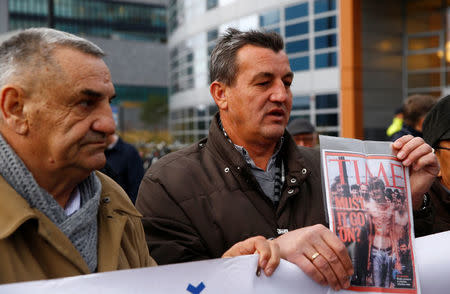 Fikret Alic, one of the survivors of concentration camps shows his photo on the cover of Time before the trial of former Bosnian Serb military commander Ratko Mladic before a court at the International Criminal Tribunal for the former Yugoslavia (ICTY) in the Hague, Netherlands, November 22, 2017. REUTERS/Michael Kooren