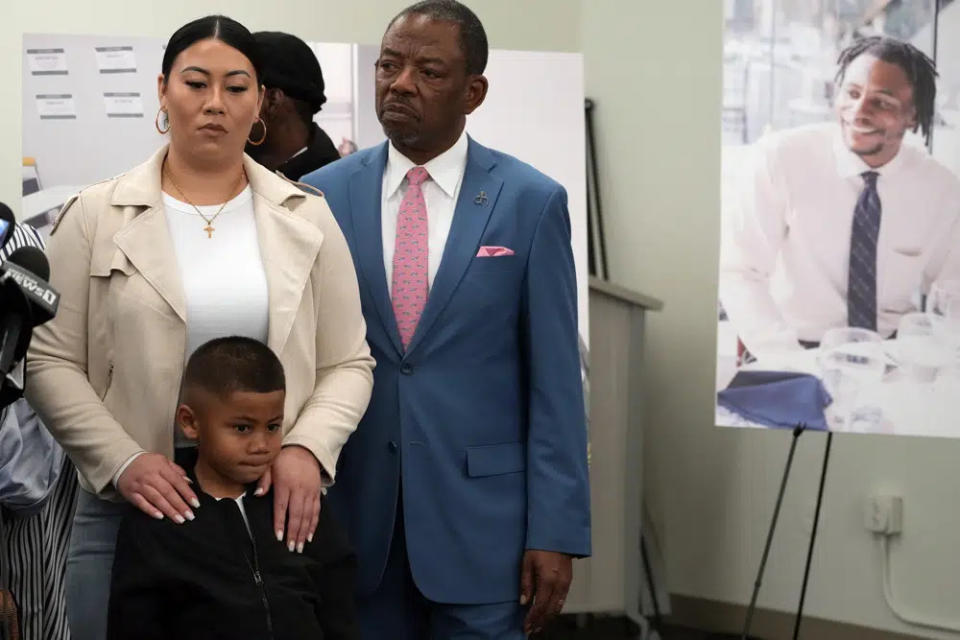 Lawyer Carl Douglas, right, holds a news conference with Gabrielle Hansel, guardian of five-year-old Syncere Kai Anderson, to announce filing a $50 million in damages claim against the city of Los Angeles over the death of Keenan Anderson, seen photo right, at a news conference in Los Angeles Friday, Jan. 20, 2023. (AP Photo/Damian Dovarganes)