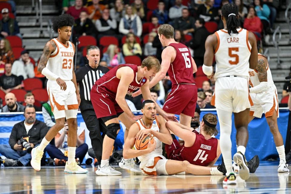Texas forward Dylan Disu reacts after a jump ball was called following a battle for the ball with Colgate's Keegan Records during the first half of Thursday night's 81-61 first-round win of the NCAA Tournament.
