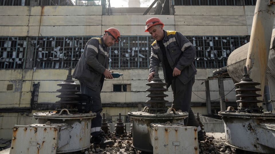 Workers check a transformer which was damaged by a Russian missile attack at DTEK's power plant in Ukraine, on Monday, April 1, 2024. - Evgeniy Maloletka/AP