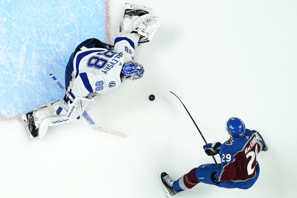 Tampa Bay Lightning goaltender Andrei Vasilevskiy (88) makes a save against Colorado Avalanche center Nathan McKinnon (29) during the first period in Game 5 of the NHL Stanley Cup Final on Friday, June 24, 2022, in Denver. (AP Photo/Jack Dempsey)