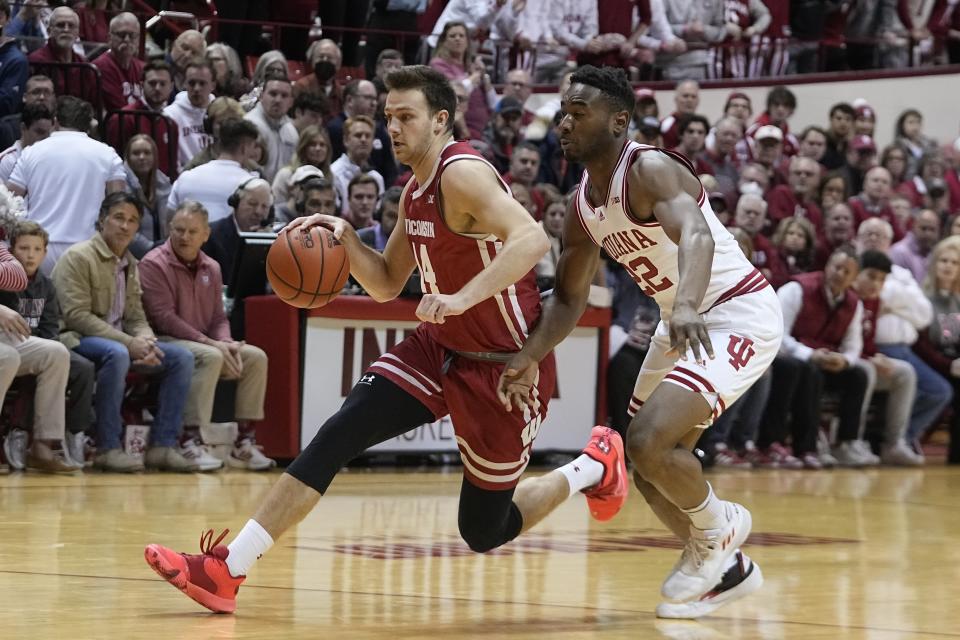 Wisconsin's Carter Gilmore (14) goes to the basket against Indiana's Jordan Geronimo (22) during the first half of an NCAA college basketball game, Saturday, Jan. 14, 2023, in Bloomington, Ind. (AP Photo/Darron Cummings)