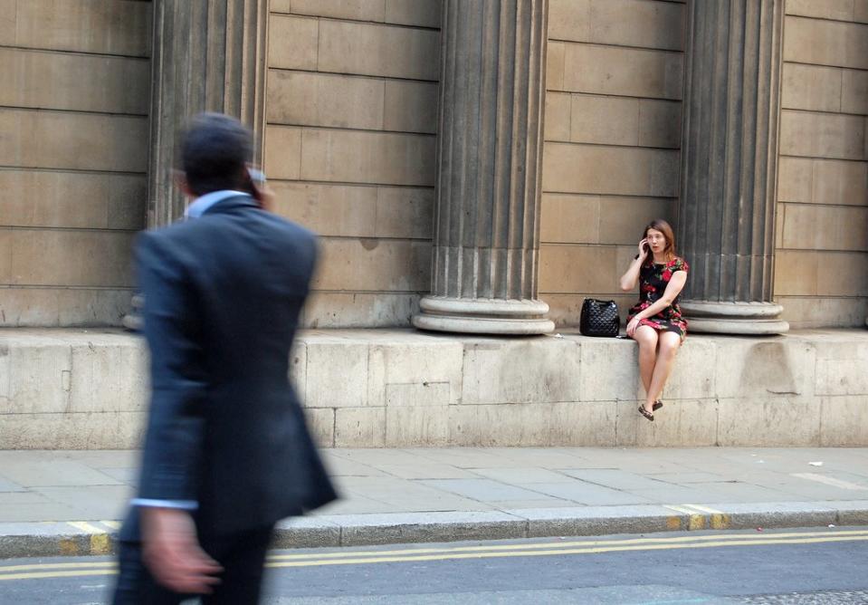 woman cell phone sidewalk