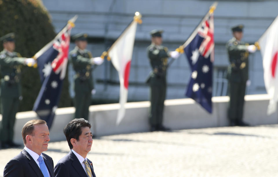 Australian Prime Minister Tony Abbott, left, and Japanese Prime Minister Shinzo Abe attend a welcome ceremony at Akasaka State Guest House in Tokyo Monday, April 7, 2014. Abbott is on a four-day official visit. (AP Photo/Koji Sasahara)