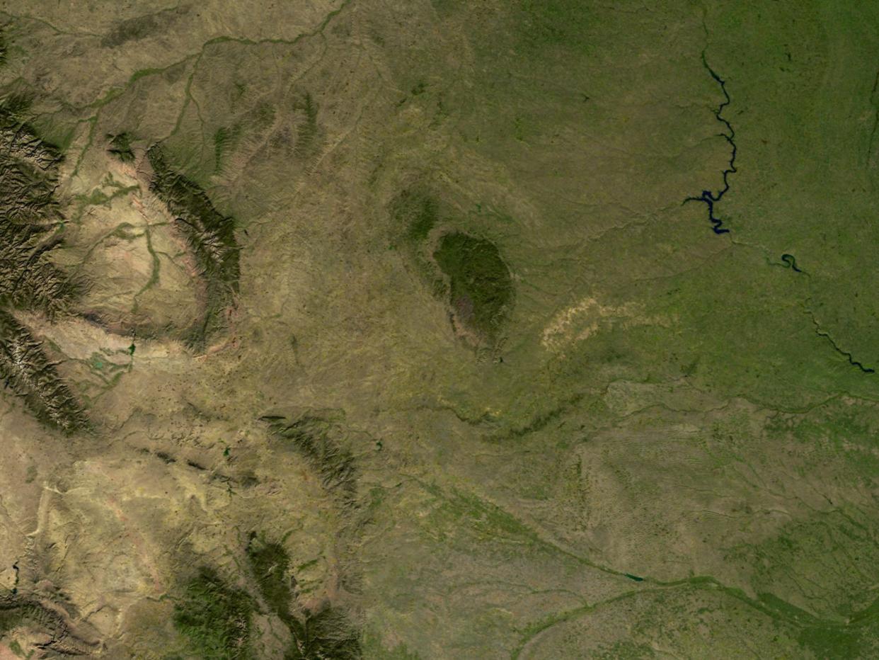 an aerial image of the Black Hills with greenery and mountains