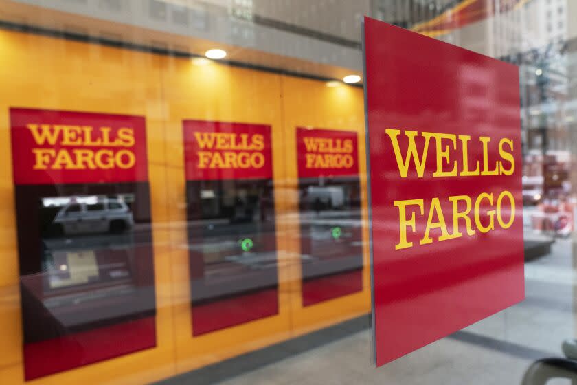 FILE - This Jan. 13, 2021 file photo shows a Wells Fargo office in New York. Wells Fargo &amp; Co. says first-quarter net income jumped to $4.74 billion from $653 million a year earlier, when the pandemic struck the global economy. The San Francisco-based bank said Wednesday, April 14, that it had earnings of $1.05 per share in the latest quarter, compared with a profit of 1 cents a year earlier. (AP Photo/Mark Lennihan, File)