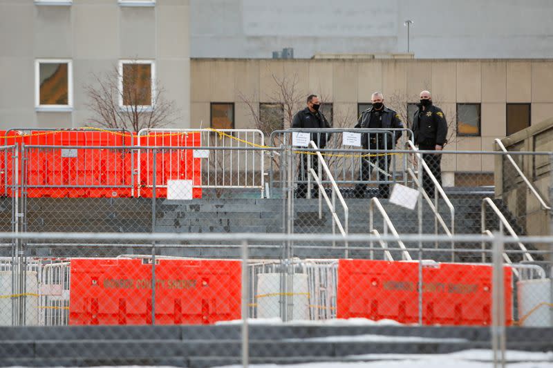 Police Officers stand behind barricades at the Monroe County Sheriff's Office after the New York grand jury votes not to indict officers in Prude's death