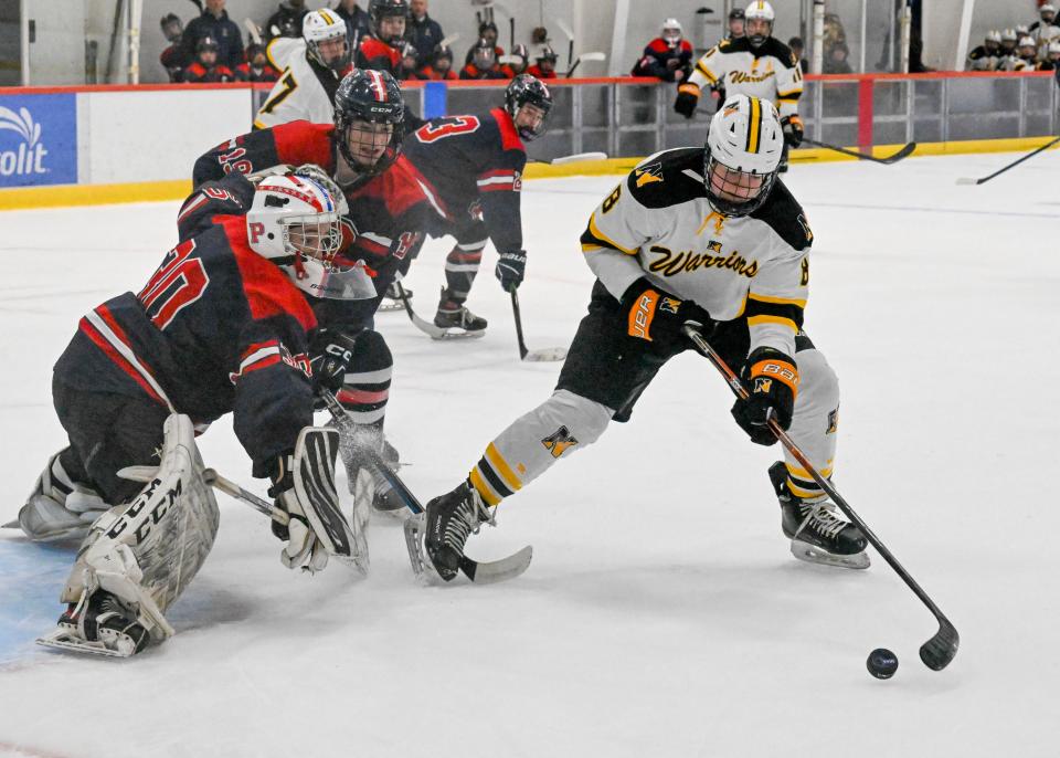 BOURNE 03/07/24 Colin Ward of Nauset turns for a shot on Pembroke goalie Kyle Ready in the elite 8 boys hockey
Ron Schloerb/Cape Cod Times