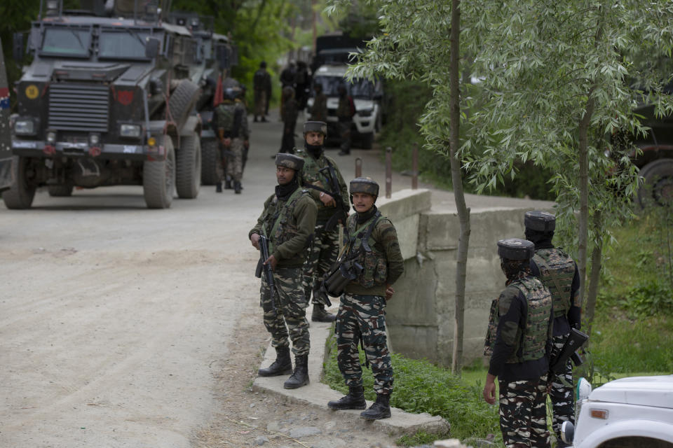 Indian paramilitary soldiers stands guard as police and army soldiers launch an operation in Awantipora area, south of Srinagar, Indian controlled Kashmir, Wednesday, May 6, 2020. Government forces killed a top rebel commander and his aide in Indian-controlled Kashmir on Wednesday and shut down cellphone and mobile internet services during subsequent anti-India protests, officials, and residents said. (AP Photo/ Dar Yasin)