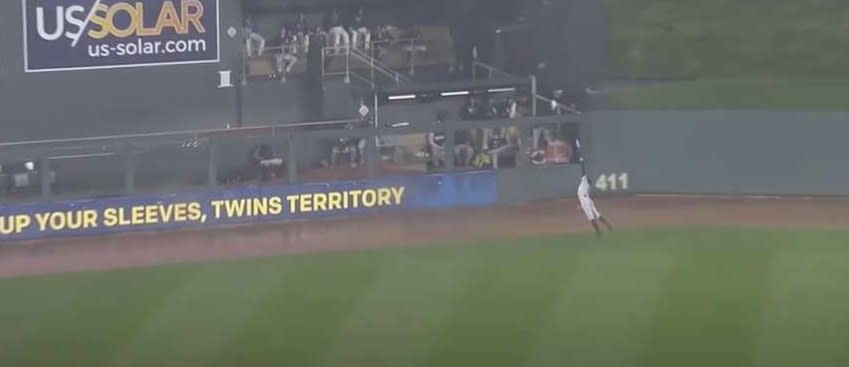 Baseball player dives in the rain