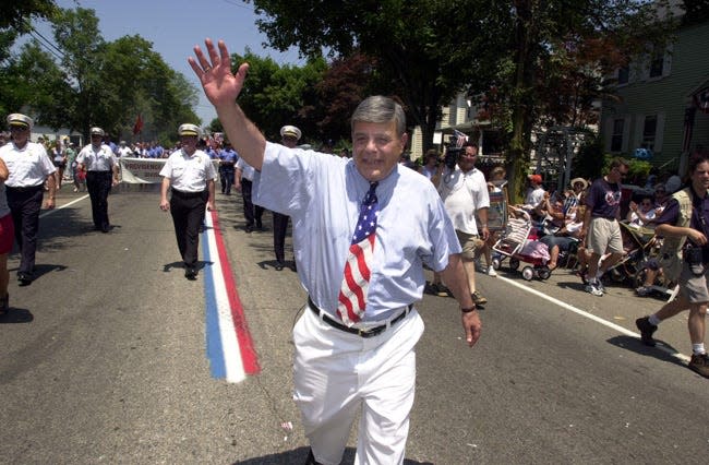 Mayor Vincent A. "Buddy" Cianci waves to the crowd from the route of the 2002 Bristol Fourth Of July Parade.