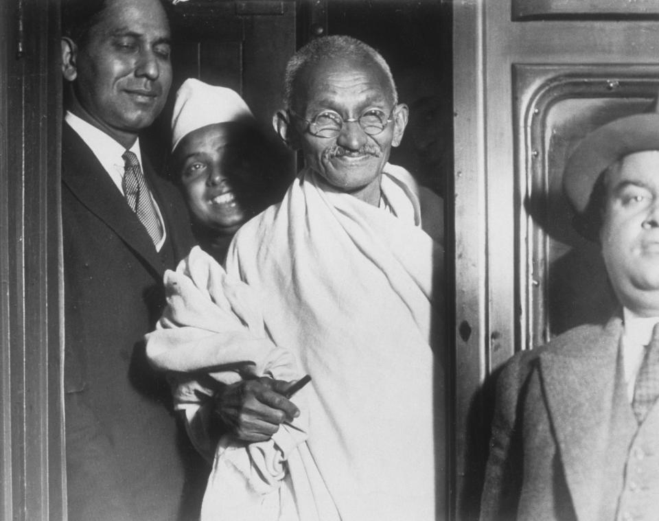 GANDHI LEAVES FOR LANCASHIRE | Gandhi at Euston station before his trip to Lancashire where he visited the cotton industry. (Photo by Hulton-Deutsch/Hulton-Deutsch Collection/Corbis via Getty Images)