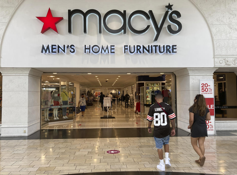 FILE - Shoppers walk into a Macy's department store Monday, Feb. 22, 2021, at Miami International Mall in Doral, Fla. Macy's reports earnings on Thursday, Nov. 16, 2023. (AP Photo/Wilfredo Lee, File)