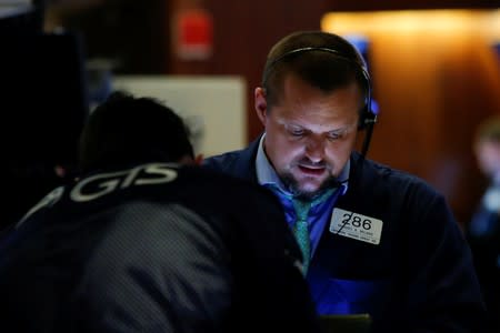 Traders work on the floor at the New York Stock Exchange (NYSE) in New York