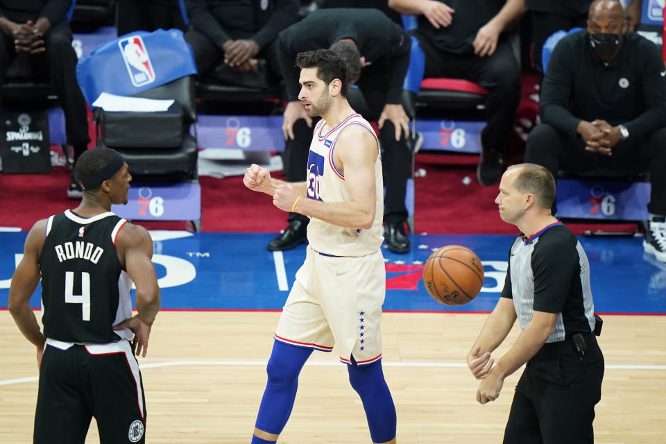 Philadelphia 76ers' Furkan Korkmaz, center, celebrates past Los Angeles Clippers' Rajon Rondo after a making basket during the second half of an NBA basketball game, Friday, April 16, 2021, in Philadelphia. (AP Photo/Matt Slocum)