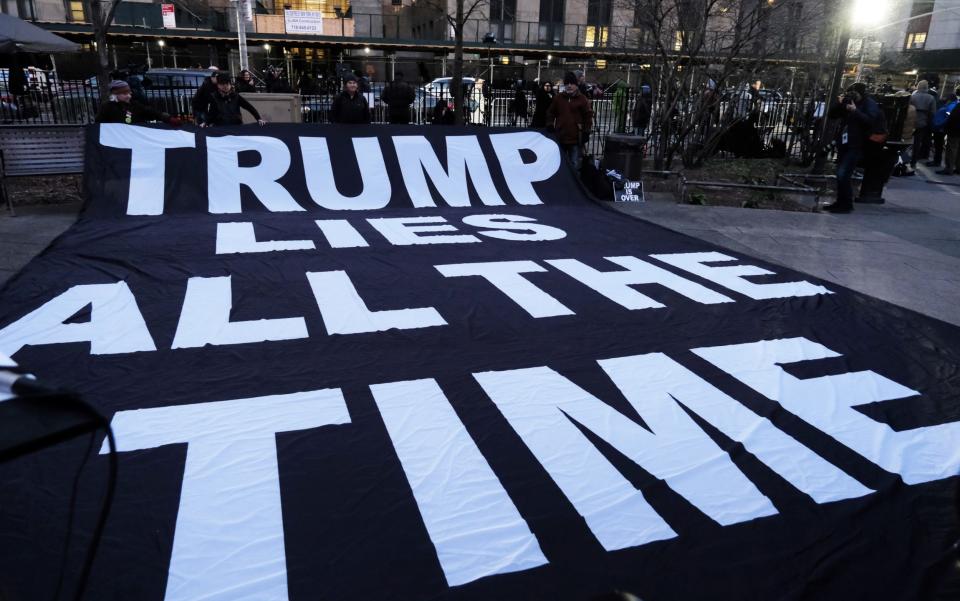 Police, media and a small group of protesters gather outside of a Manhattan courthouse after news broke that former President Donald Trump has been indicted - Spencer Platt/Getty Images