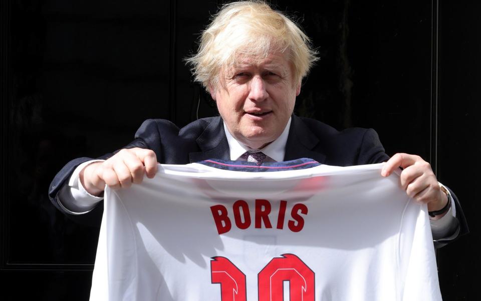 Boris Johnson holds up and England shirt with his name on it outside No 10 - Boris Johnson's Euro 2024 advert axed after revolt from Paddy Power staff