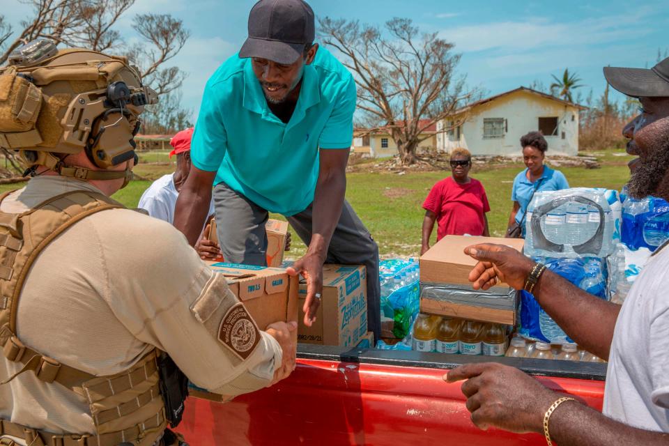 In this image courtesy of US Customs and Border Protection (USCBP), USCBP agents deliver food and water to severely damaged Fox Town on the Abaco Islands in the Bahamas, on September 6, 2019, in the aftermath of Hurricane Dorian. - The death toll from Hurricane Dorian's devastating rampage across the Bahamas rose to 43 and was likely to climb 