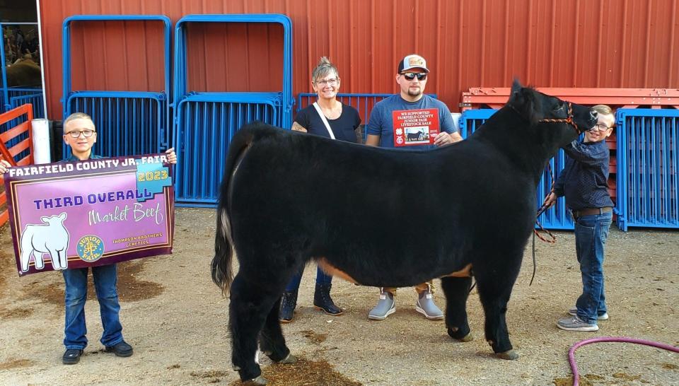 Josh Brunney and his mother Nichole Ruetsch with Cooper and Cam Lee and Ja'Marr Chase the steer.
