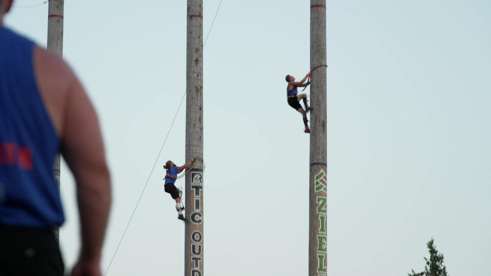 Racing through the 60-foot and 90-foot climbing events. Spiked boots help on the way up! / Credit: CBS News