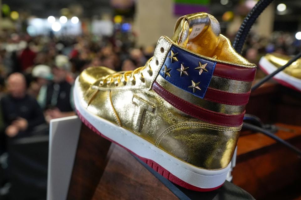 Gold Trump sneakers sit on the podium after Republican presidential candidate former President Donald Trump spoke at Sneaker Con Philadelphia, an event popular among sneaker collectors, and announces a gold Trump sneaker, in Philadelphia, Saturday, Feb. 17, 2024.