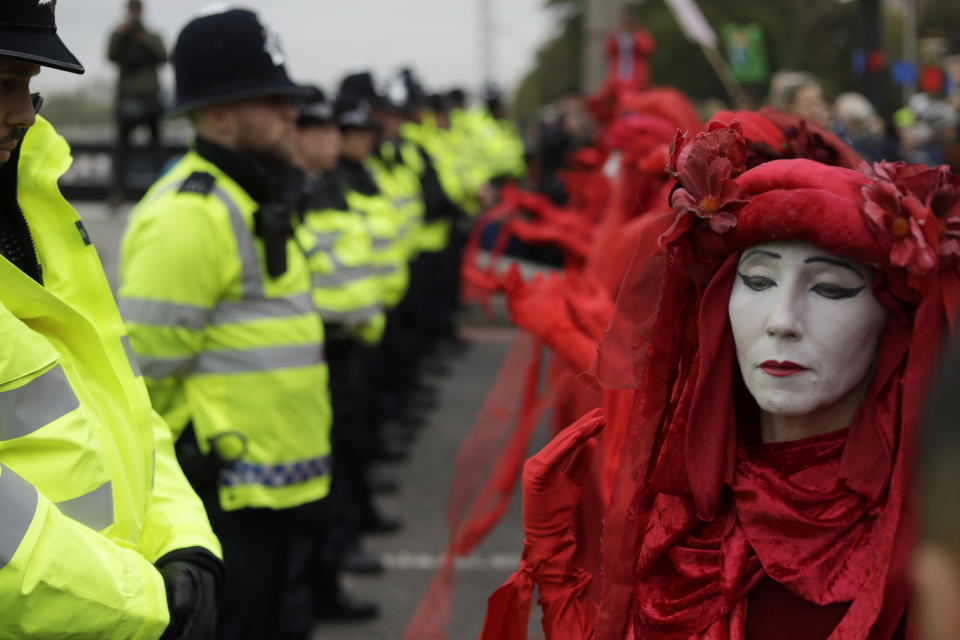 Environmental protestors face police on Lambeth bridge in central London Monday, Oct. 7, 2019. (Photo: Matt Dunham/AP)