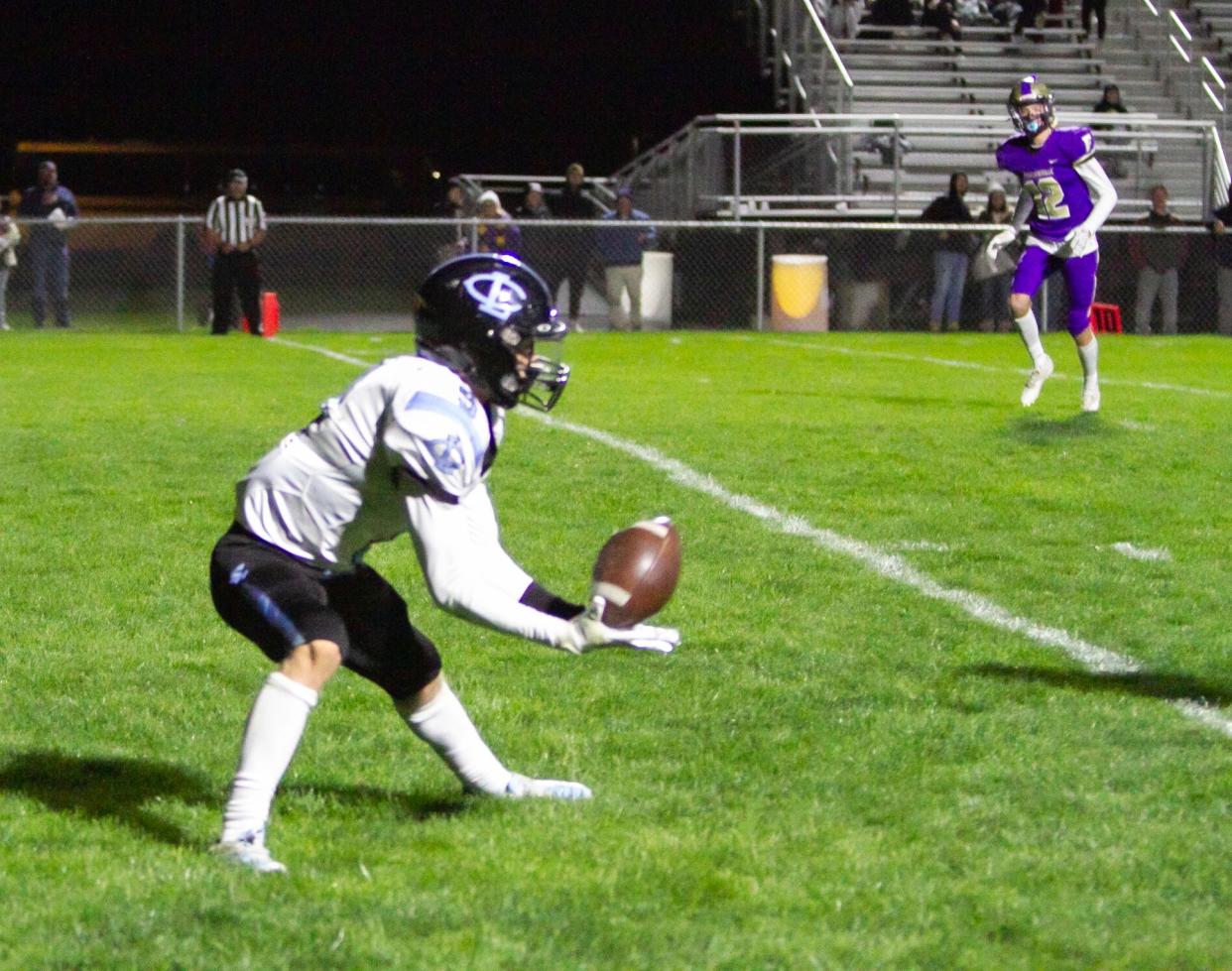 Braden Rabideau of Lansing Catholic catches this pass in Fowlerville's endzone for a touchdown in the Gladiators' home game Friday, Oct. 14, 2022.