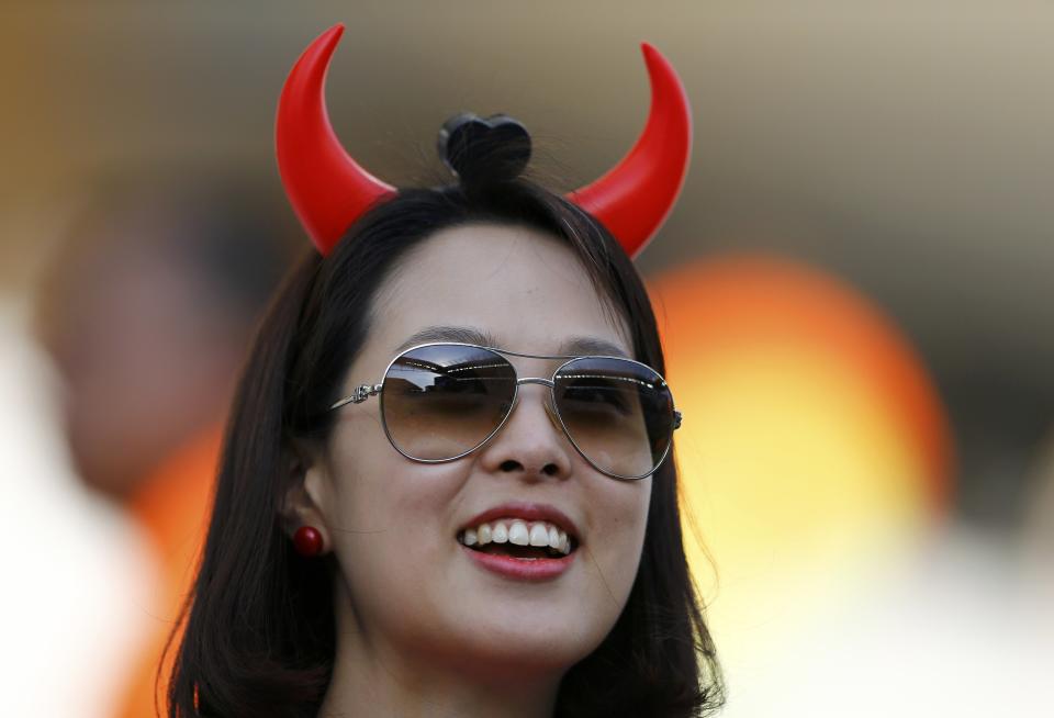 A South Korea fan smiles before the 2014 World Cup Group H soccer match between Belgium and South Korea at the Corinthians arena in Sao Paulo June 26, 2014. REUTERS/Ivan Alvarado (BRAZIL - Tags: SOCCER SPORT WORLD CUP)