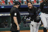 Miami Marlins' Miguel Rojas, right, argues with home plate umpire Dan Bellino after striking out during the seventh inning in Game 2 of a baseball National League Division Series Wednesday, Oct. 7, 2020, in Houston. (AP Photo/Eric Gay)