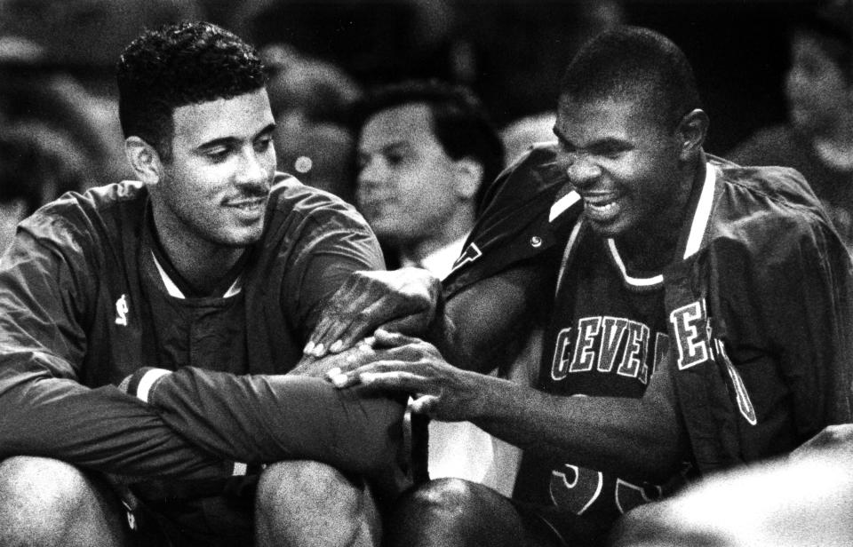 Mike Sanders and Brad Daugherty share a joyous moment during the final minutes of a blowout Cleveland Cavaliers victory against the Chicago Bulls at the Richfield Coliseum on May 22, 1992, in Richfield, Ohio.