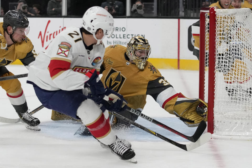 Vegas Golden Knights goaltender Adin Hill (33) blocks a shot by Florida Panthers center Nick Cousins (21) during the third period of an NHL hockey game Thursday, Jan. 12, 2023, in Las Vegas. (AP Photo/John Locher)