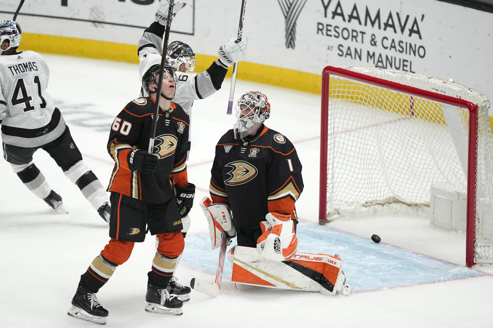 Los Angeles Kings center Trevor Lewis, second from right, celebrates a goal by defenseman Matt Roy as Anaheim Ducks defenseman Jackson LaCombe second from left, and goaltender Lukas Dostal, right, react during the second period of an NHL hockey game Saturday, April 13, 2024, in Los Angeles. (AP Photo/Mark J. Terrill)